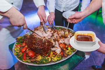 roast leg of pork in a dish with vegetables