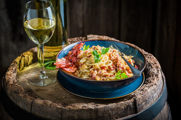 Fresh spaghetti Carborana with white wine on old barrel