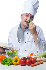 chef with recipe book thinks about cooking vegetables