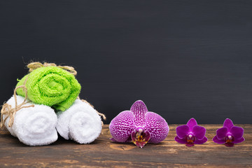 towel spa with beautiful flowers on a dark background