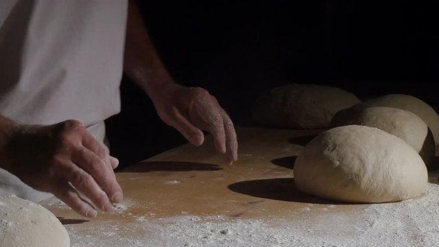 A baker clapping with flour powder in hands spotlight 4k 11773 
