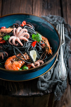 Spicy seafood black pasta made of octopus, tiger prawns
