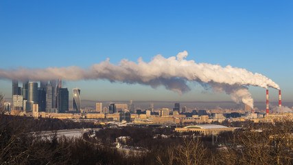 power plant emitting smoke and vapor in cold weather,