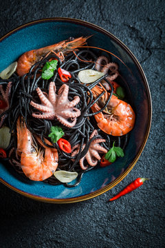 Delicious seafood black pasta made of octopus, tiger prawns