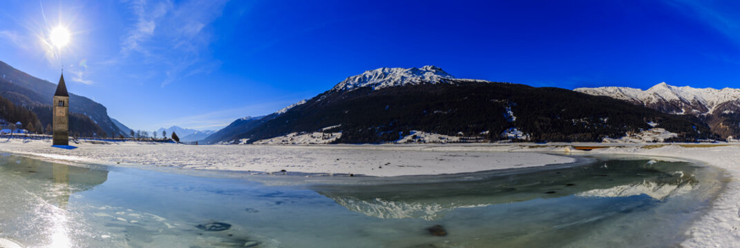 Panorama of the Resia/Reschen Lake  adorned with a Romanesque ch