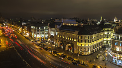 Fototapeta na wymiar panorama of urban roofs and night traffic