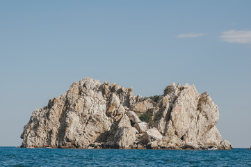 Rock on a background of blue sea. Beautiful seascape