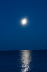 Moon in the night sky in the background of the sea