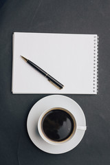 cup and saucer, drink and notebook with pen
