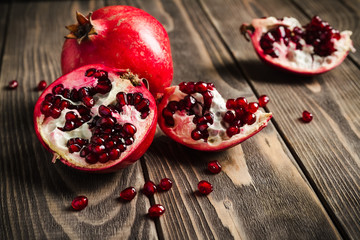 Ripe pomegranate fruit on rustic vintage background