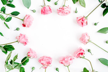Frame made of pink roses on white background. Flat lay, top view. Valentine's background