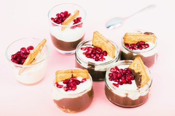 Six glass bowl with sweet dessert with chocolate and vanilla mousse.
