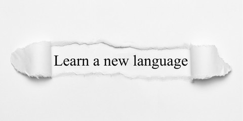 Learn a new language on white torn paper