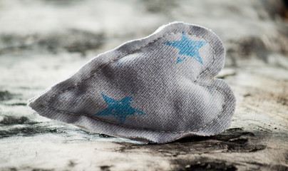 Obraz premium Heart made of cloth on wood desk