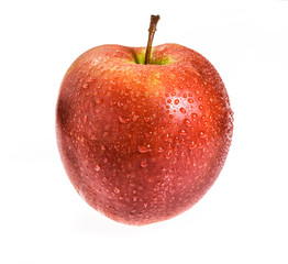 Water drops on a red Apple. Isolated on a white background.