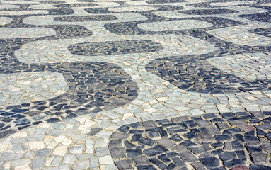 Black and white iconic mosaic, Portuguese pavement by old design pattern at Ipanema beach, Rio de...