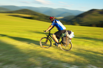 Fototapeta na wymiar Tourist on bicycle with mountain on background, Slovakia, pannin