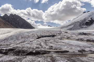 Group of climbers goes down the pass in the mountains on the rop