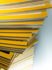 Stack of yellow monthly magazine
