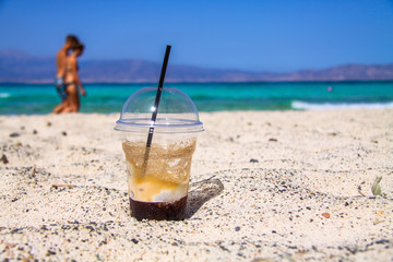 Frappe (cold cappuccino) on the carribean beach, Chrissi Island, Greece