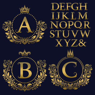 Vintage monogram kit. Golden letters and floral coat of arms frames for creating initial logo in antique style.