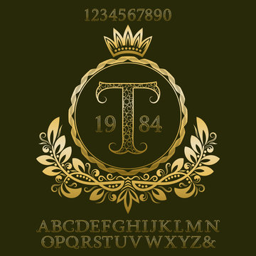 Golden patterned letters and numbers with initial monogram in coat of arms form. Elegant font and elements kit for logo design.
