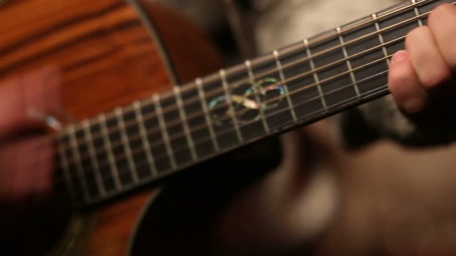 Man playing acoustic guitar close up