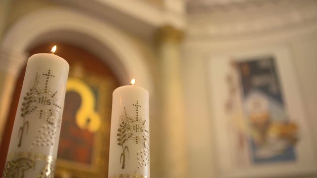 Mother of God against candles in church.