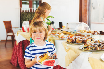 Kids choosing breakfast in restaurant