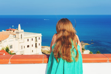 Fototapeta na wymiar Little kid girl admoring beautiful sea view, image taken in Tropea, Calabria, South of Italy