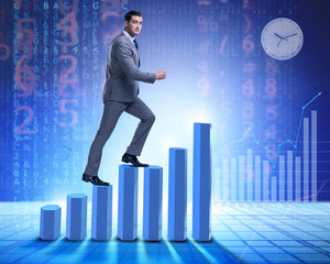 Fototapeta premium Businessman climbing bar charts in business concept