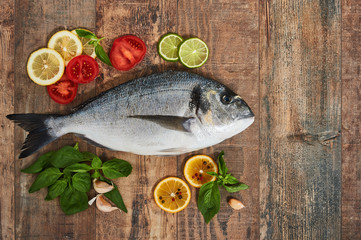 Fresh uncooked dorado on wooden table.
