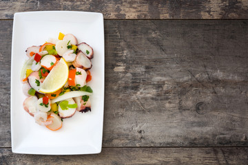 Traditional seafood ceviche from Peru on wooden background
