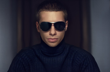 Fashion portrait of young handsome man in sunglasses.