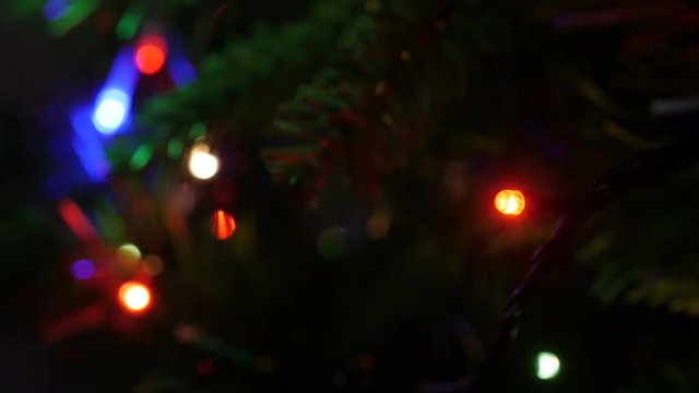 Blinking decorative bulbs on New Year night close-up 4K 2160p 30fps UltraHD footage - Christmas fairy lights sequence on artificial tree 3840X2160 UHD video 