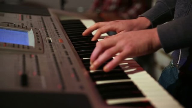 Young man playing electronic keyboard