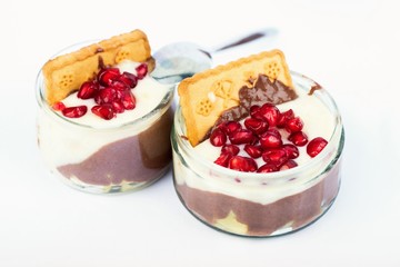 Two bowl with vanilla and pomegranate mousse on white background.