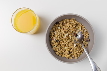 Granola breakfast cereal and orange juice drink