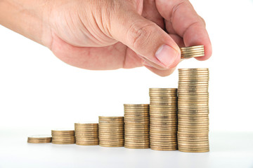 man hand putting money to rising coin stacks on white background