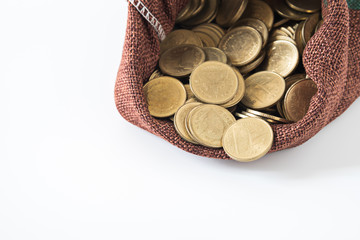 coins splash out of full of coins bag on white background showin