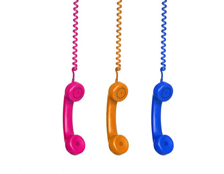 Three colorful phones hanging from a cable