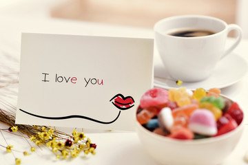 postcard with the text I love you on a table