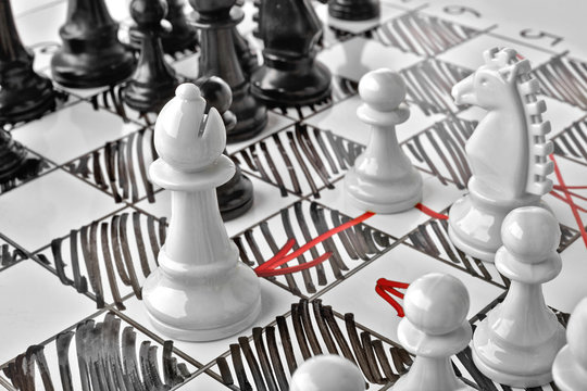 Chess, white's attack. White board with chess figures on it. Plan of battle.