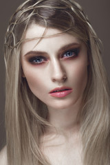 Beautiful fashion woman with creative make-up and hairstyle. The beauty of the face. Photos shot in the studio.