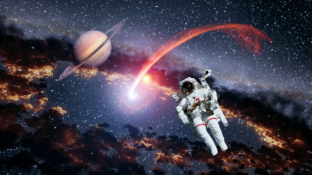 Astronaut planet Saturn spaceman comet outer space suit galaxy universe. Elements of this image furnished by NASA.
