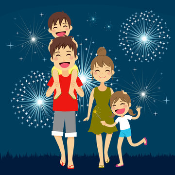 Happy Family Walking Together On Summer Holiday Night With Fireworks In The Background