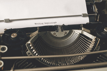 Writing beginnings typed words on Vintage Typewriter