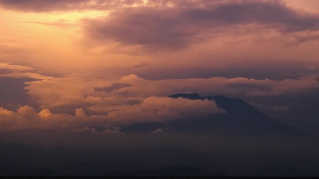 Time lapse of the sunset with clouds over volcano of Agung, Bali, Indonesia