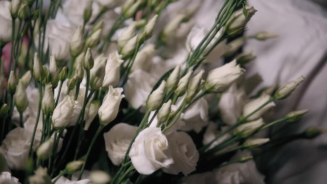 Close up view of florist preparing flower composition at workplace,bouquet of roses peone and lilac for valentine's day and women's day