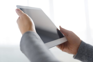 Hands hold tablet simple close up